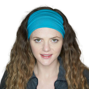 Women looking into the camera wearing an aqua bamboo yoga headwrap