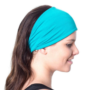 Side view of women wearing aqua bamboo yoga headband