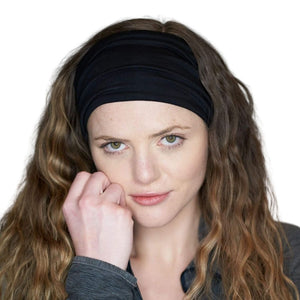 Women staring at the camera with hand on her chin wearing black bamboo yoga headband