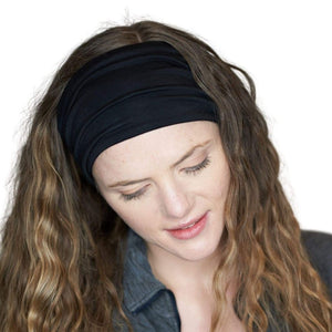 Women looking towards the ground wearing black bamboo sports sweatband