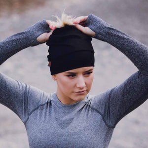 Women wearing black merino wool beanie outside in winter
