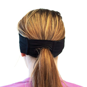 women wearing blue-aqua reversible winter sports headband with view of pony tail slot