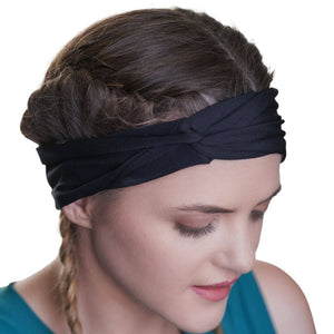 close up of women wearing black moisture wicking headband with knot at front.
