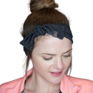 Women wearing black adjustable tie behind workout sweatband