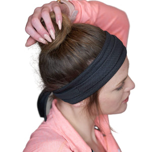 Women wearing black adjustable tie behind workout sweatband