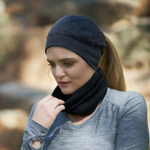 women outside looking towards the ground wearing merino wool neck warmer and ponytail friendly beanie