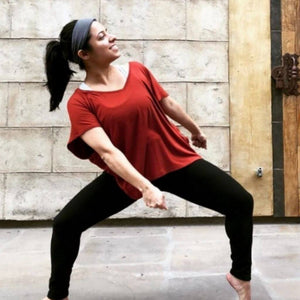 women dancing standing on toes with knees bent wearing grey bamboo headband