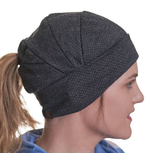 Sideview of women wearing ponytail friendly merino wool beanie