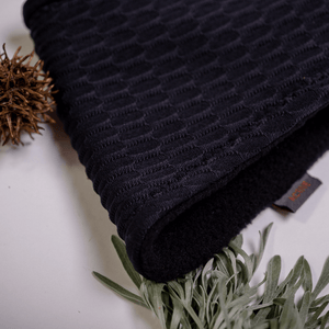 Close up of recycled black Polartec fleecy lined ear warmers