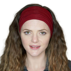 Women looking into the camera wearing red yoga bamboo headband