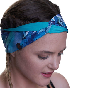 Closer view of women wearing patterned sweatwicking headband with twist at the front. 