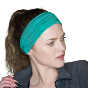 Women looking sidewise wearing green bamboo headwrap