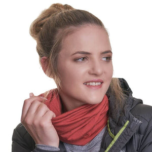 Women wearing ochre coloured ZQ merino wool neck warmer while looking sideways.