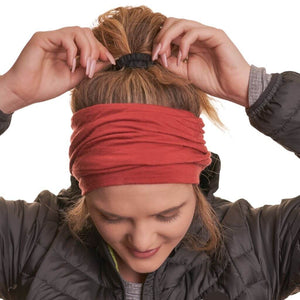 women wearing zq sustaible merino wool beanie as a thick headband while looking at the ground