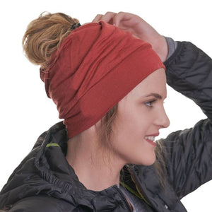 Side view of women wearing ochre coloured ZQ merino wool beanie smiling