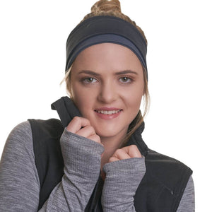 Women wearing reversible black and grey winter headband with hands holding vest colour around her neck