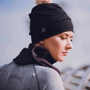 Close up of women wearing black merino wool beanie outside in winter