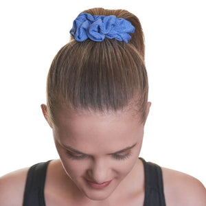 Women wearing blue gyn workout scrunchie looking to the floor