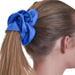 Cloase up view of women wearing gym sports scrunchie holding her hair in a ponytail
