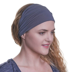 women wearing wide bamboo yoga headband with a grey/blue striped top