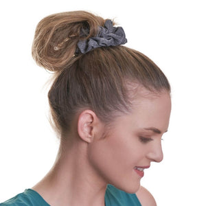 women wearing gray workout scrunchie looking sideways