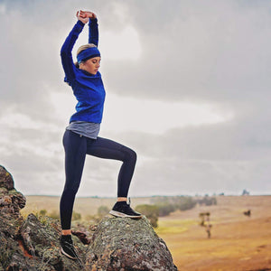 women taking in a beautiful view while wearing dark blue-marine-aqua reversible winter sports headband