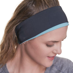 Close up of women wearing black ponytail friendly reversible winter headband gazing to the left