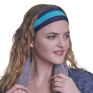 women wearing reversible blue and aqua gym headband with grey towel draped around her neck