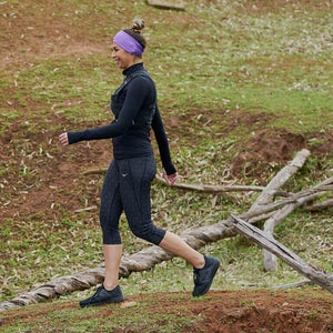 Women hiking while wearing a purple/lilac reversible sports headband