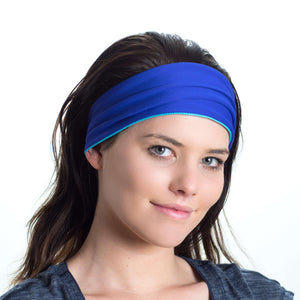 Women wearing a aqua/purple reversible exercise headband