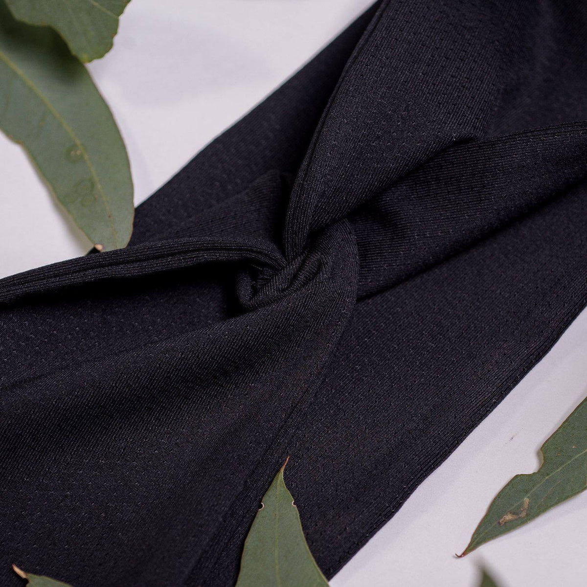 Close up fabric used for black reversible sports headband