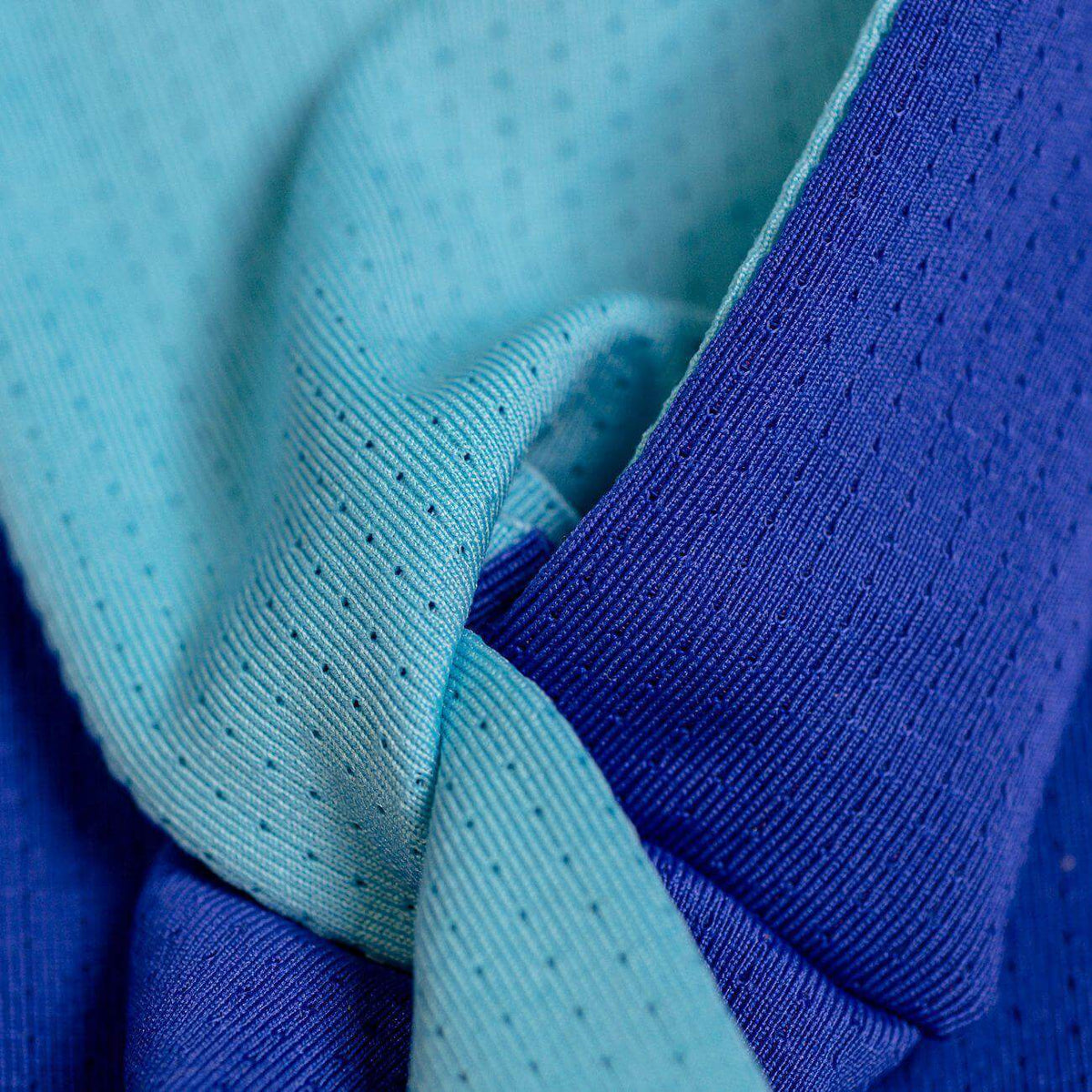 Close up of aqua/purple reversible sports headband