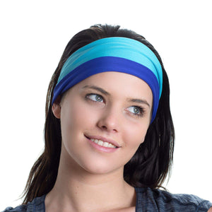 Women wearing a aqua/purple reversible active sweatband