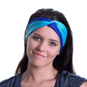 Women wearing a aqua/purple reversible sports headband with colour cross over