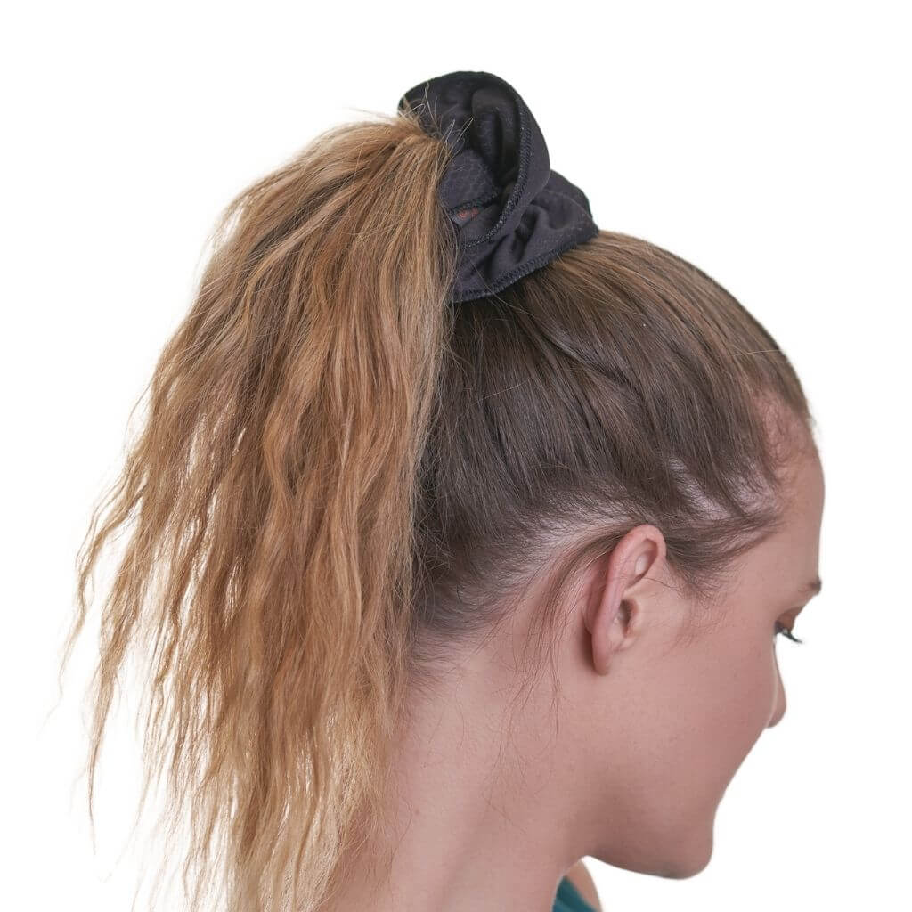 Side view of women wearing black running scrunchie
