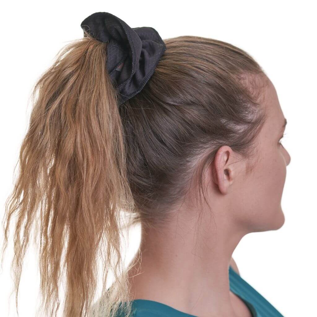 Side view of women wearing black gym scrunchie