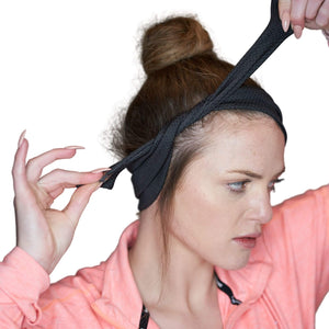 Women showing how to tie black adjustable tie behind sports headband