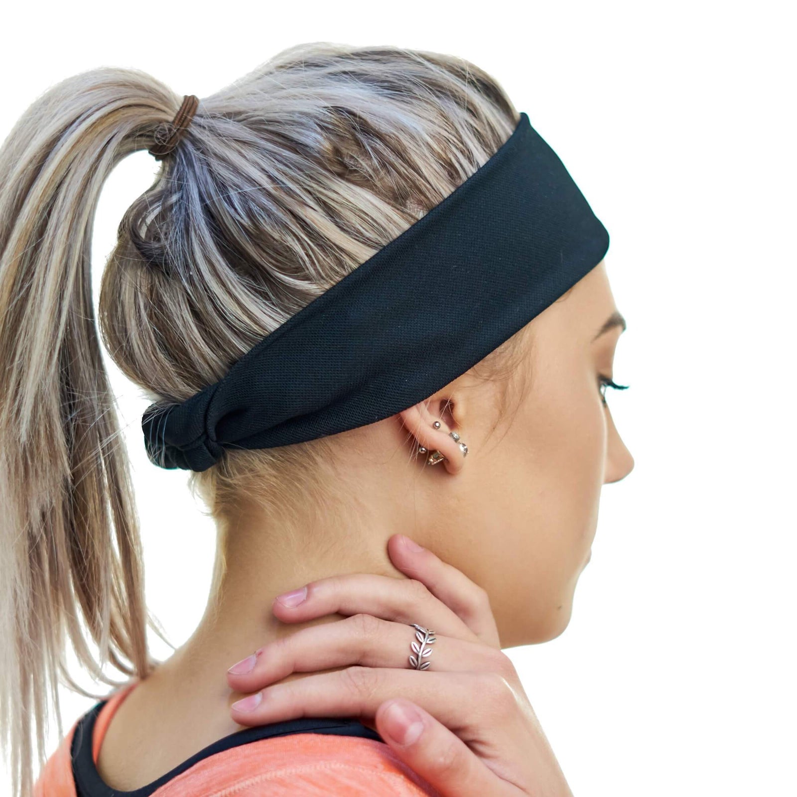 Women wearing black tie behind sports headband
