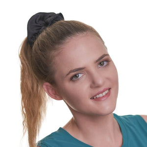 Front view of women wearing black workout scrunchie looking at the camera