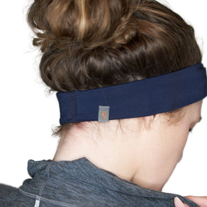 back view of women wearing navy blue bamboo yoga headband