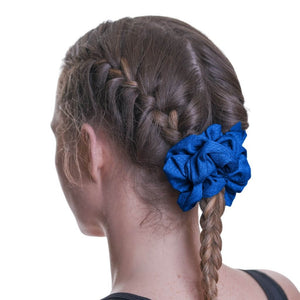 Back view of women wearing dark blue exercise scrunchie used to keep braids together