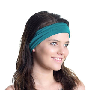 Women smiling while gazing to the left wearing teal bamboo sports headband.