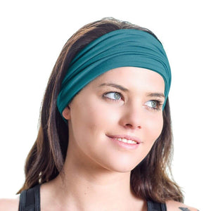 Women wearing teal bamboo sports headband looking sidewise