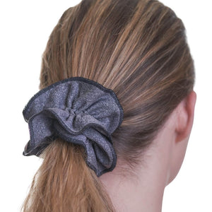 Close up of charcoal scrunchie being used to hold up a ponytail