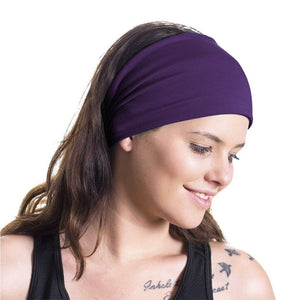 Women wearing plum coloured bamboo yoga band looking down at shoulder