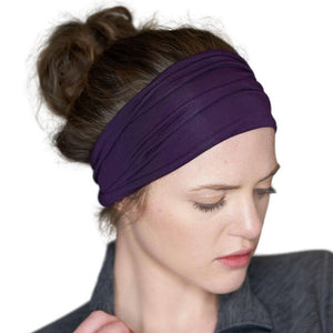 Women looking sidewise wearing plum coloured bamboo exercise headband