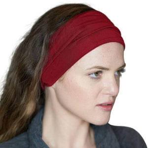 Women wearing red exercise bamboo sports headband looking sidewise
