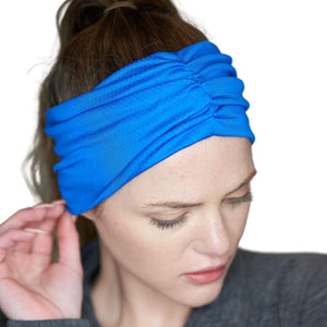 Women wearing royal blue moisture-wicking exercise sweatband