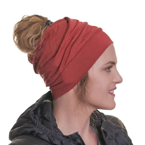 Side view of women wearing ZQ 100% mernio wool ochre coloured ponytail friendly beanie