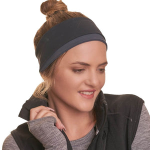 Women wearing black and grey reversible sports winter headband while smiling gazing to the left